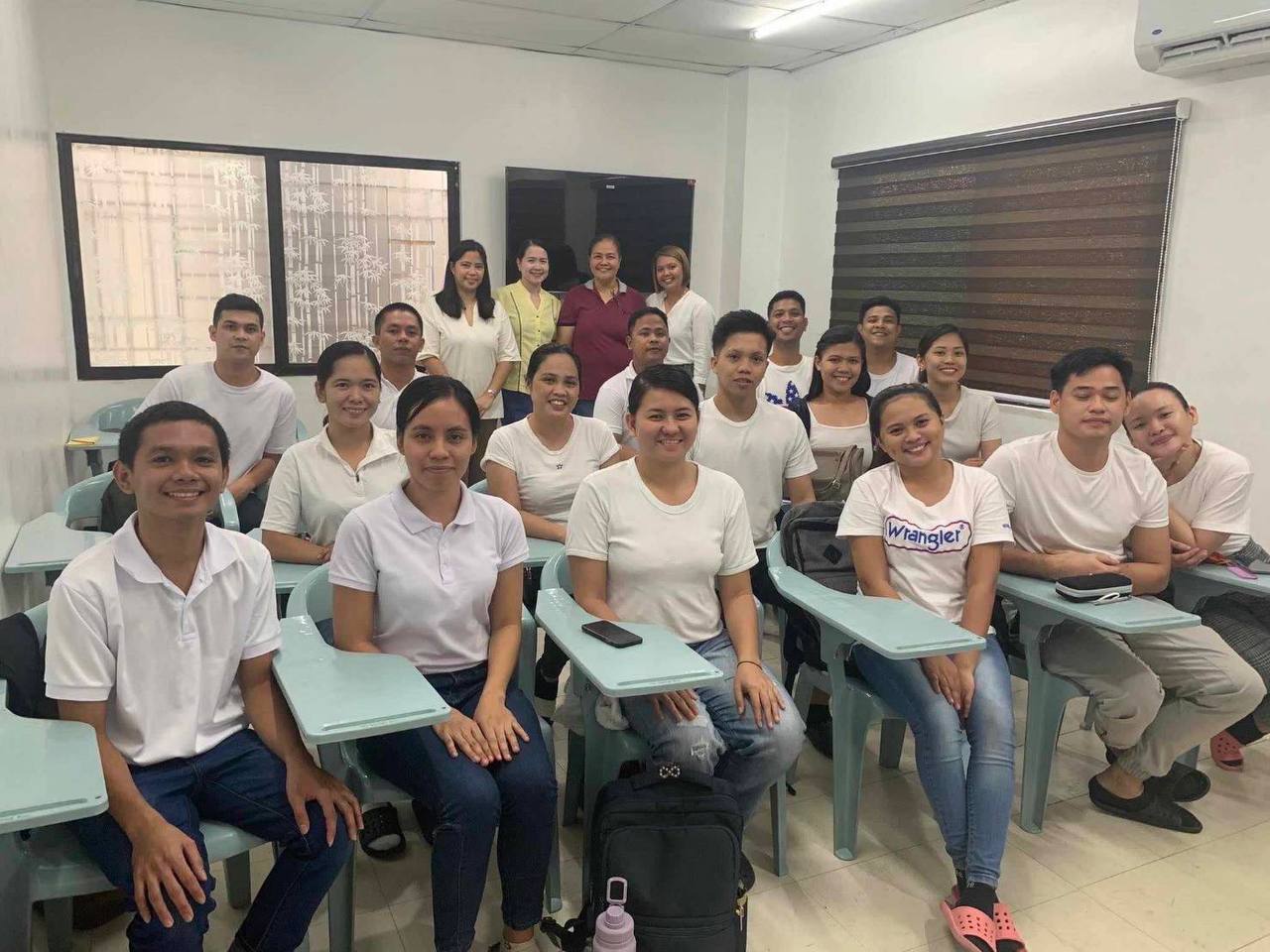 Collection of four insulated travel bottles on wooden shelf.